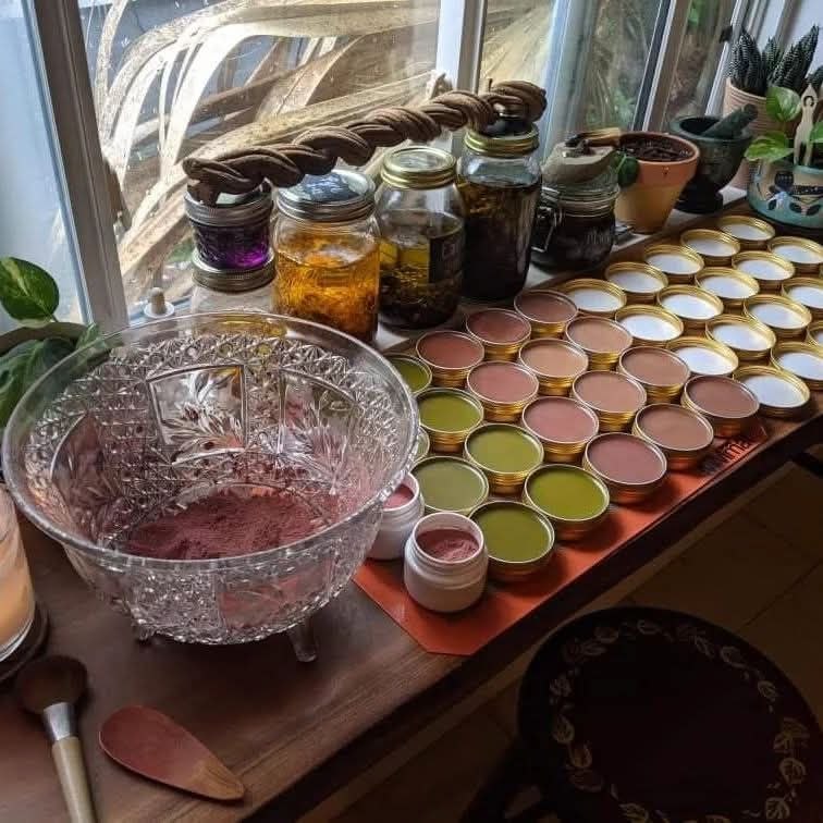 Apothecary table — herbal salves, oils and infusions in preparation