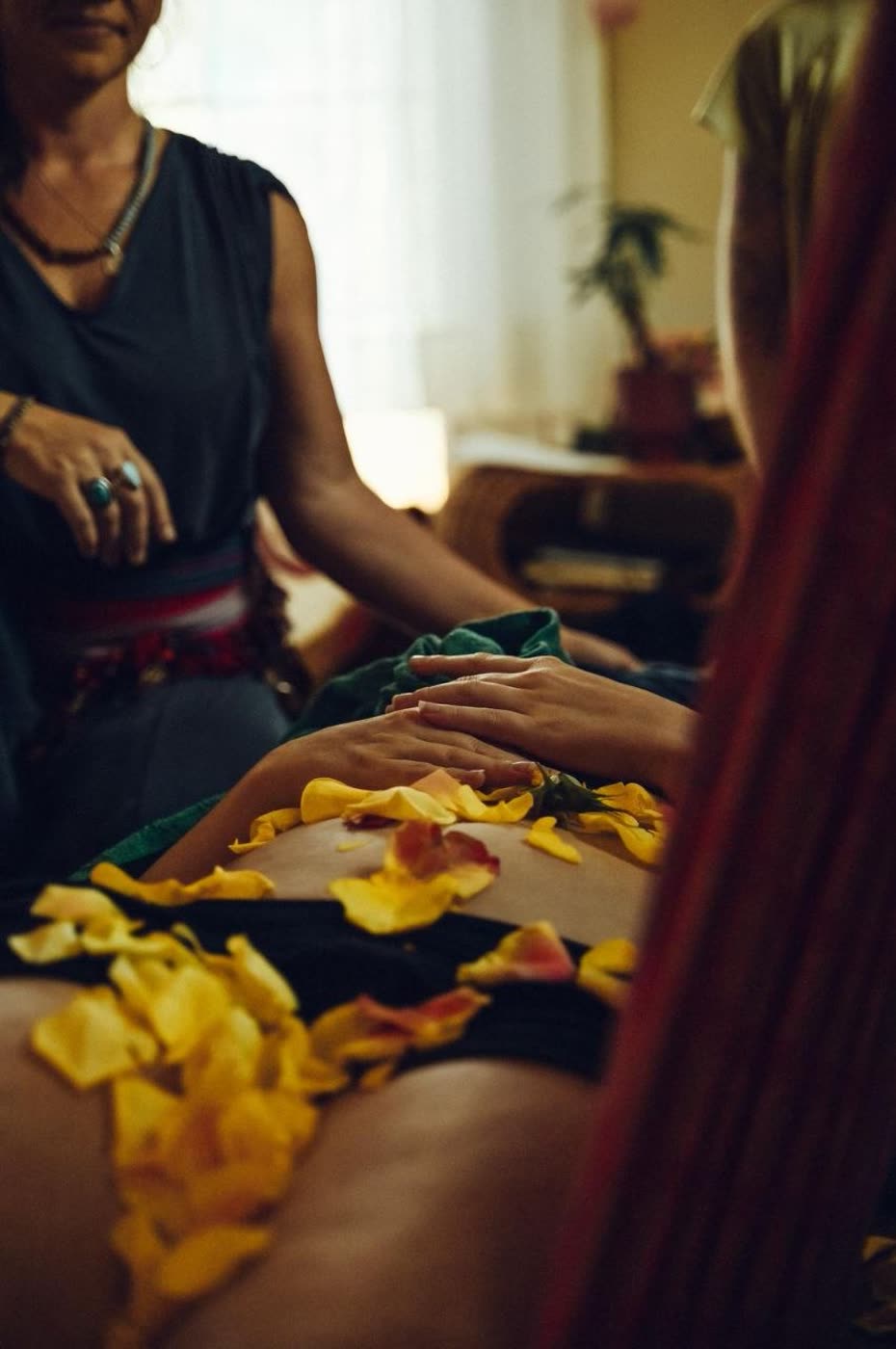 Closing of the Bones ceremony — rose petals and hands on the body