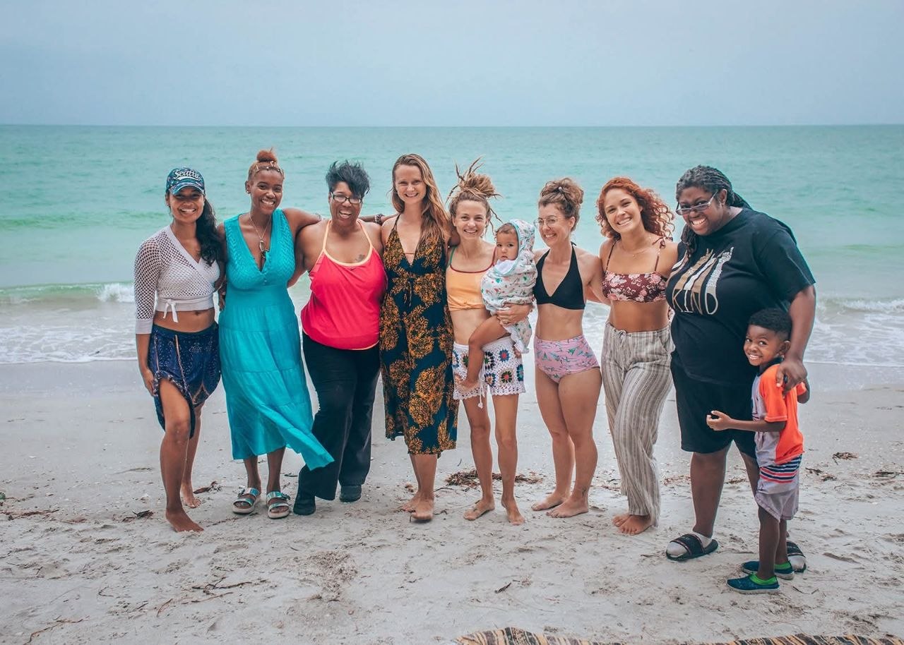 Kelli and her community of mothers and doulas at the beach