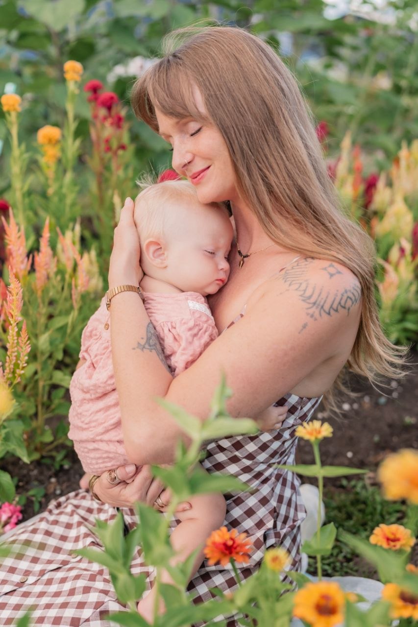 Kelli Harper holding Harper in the garden